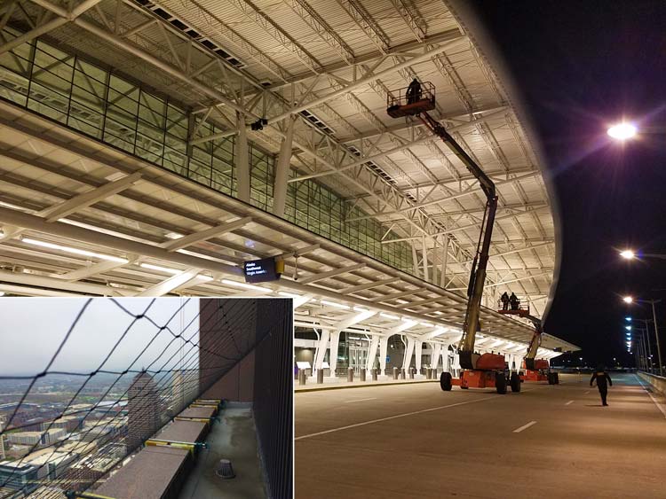 Technician installing commercial bird netting from a lift